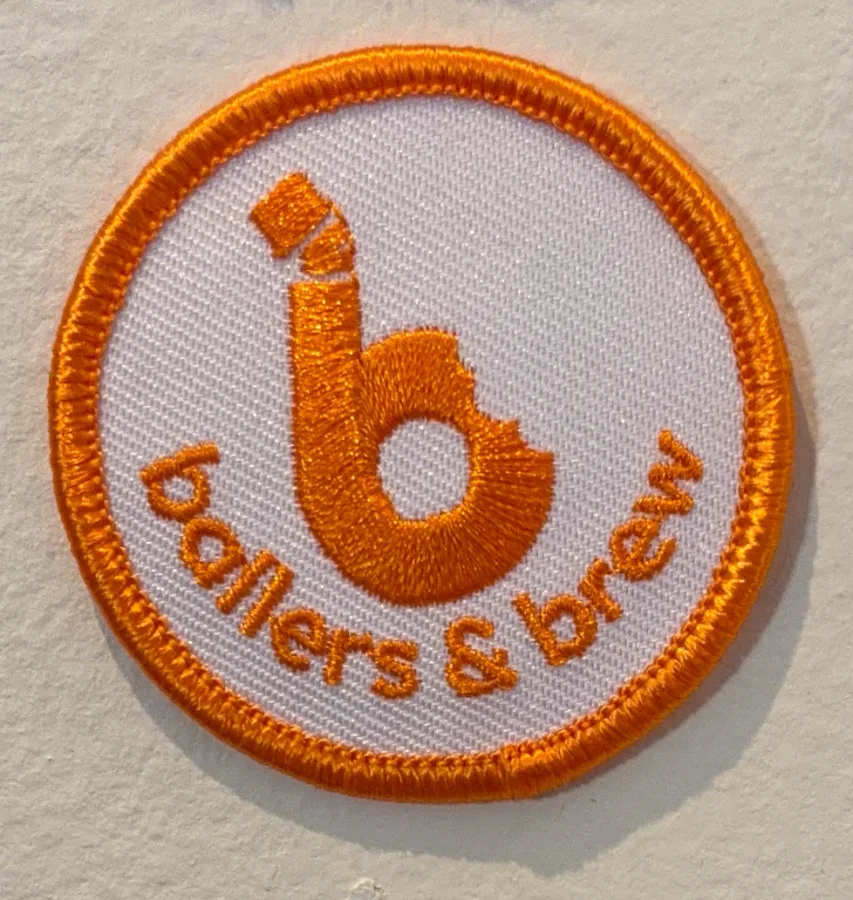 A round Ballers & Brew patch
