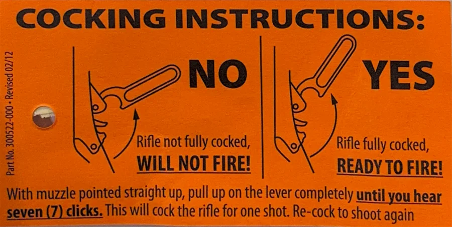 An orange rifle cocking-instructions sticker