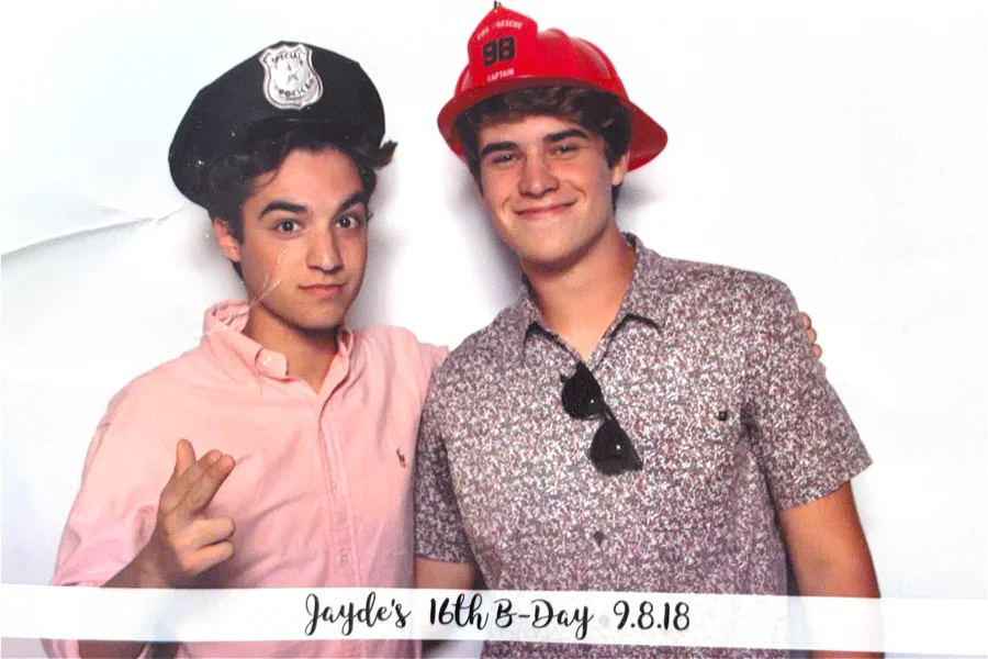 A photo booth shot: a police hat and a fire helmet