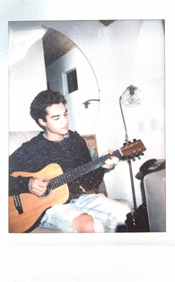 A polaroid of me playing guitar