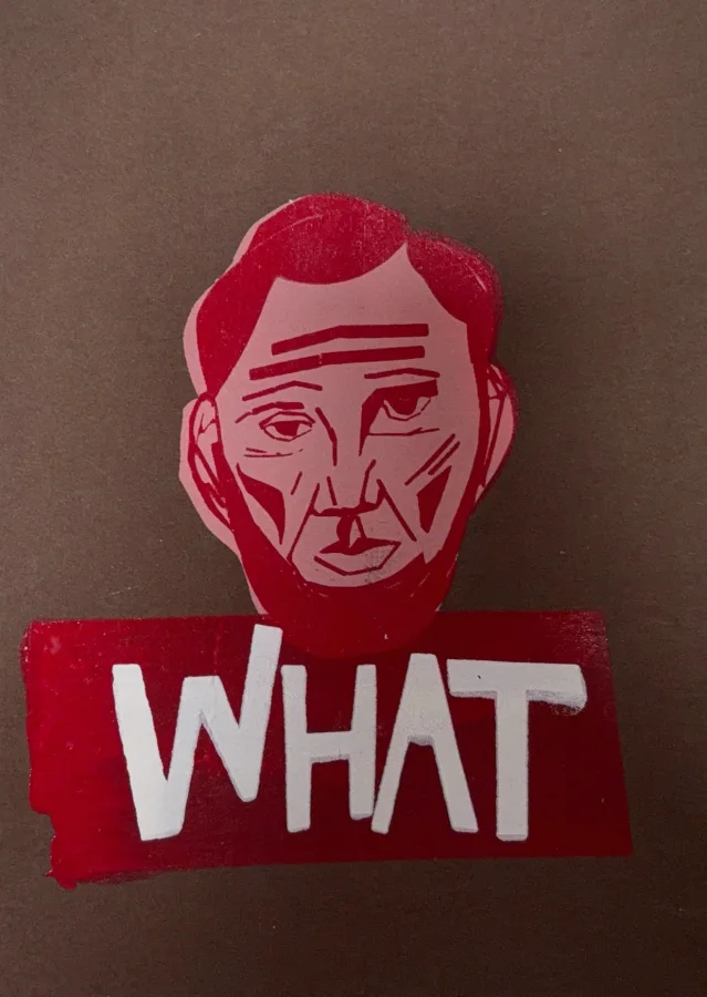 A red stencil print of a face over the word WHAT